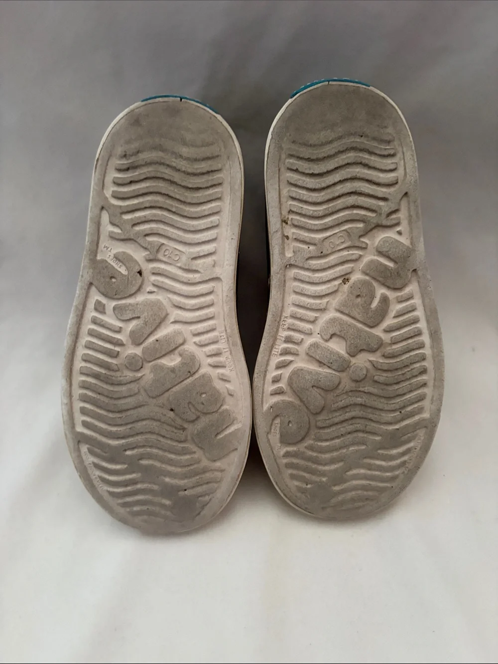 Native Gray Slip-On Kids Shoes with Cream Soles and Teal Heel Logo